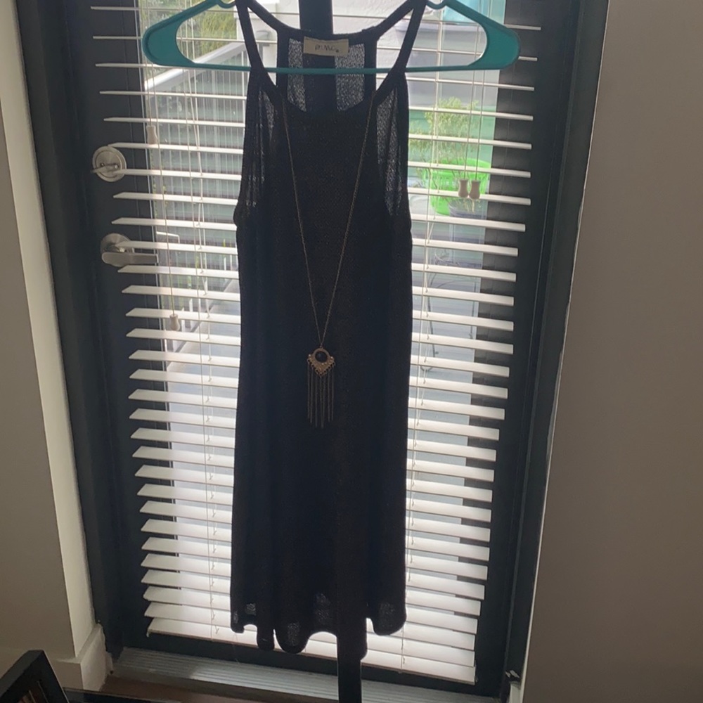 size medium, pinkish blackish, and has a very long necklace in it